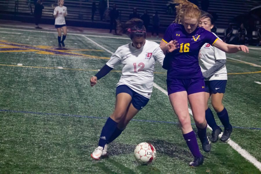 Abigail Hall (25) competes with a Dublin player to score a pass.
