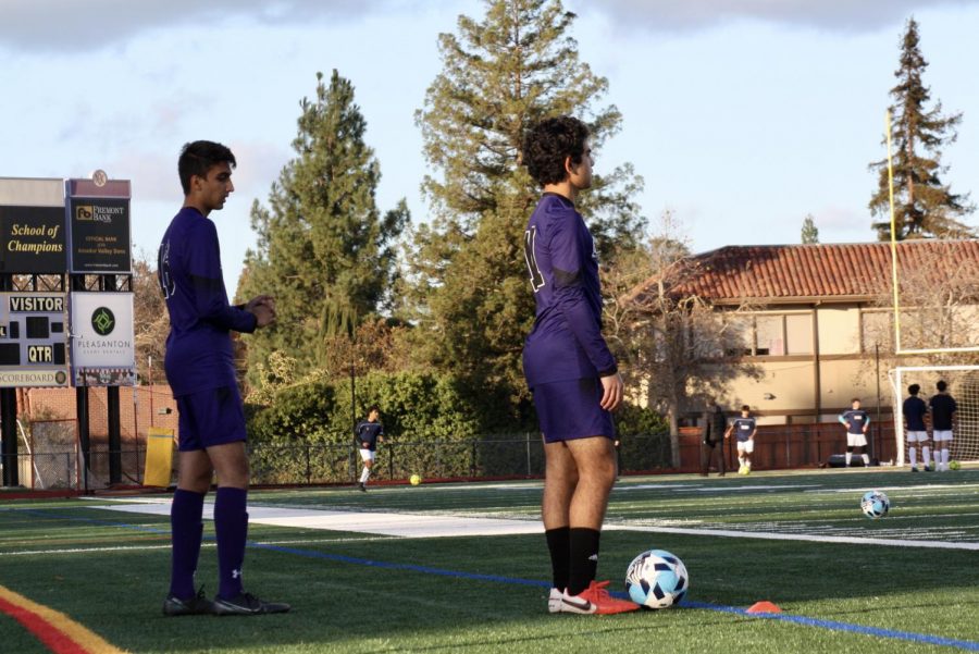 Ajay Reyes ('24), and Saksham Nirvan ('23) warm up before the game begins. 