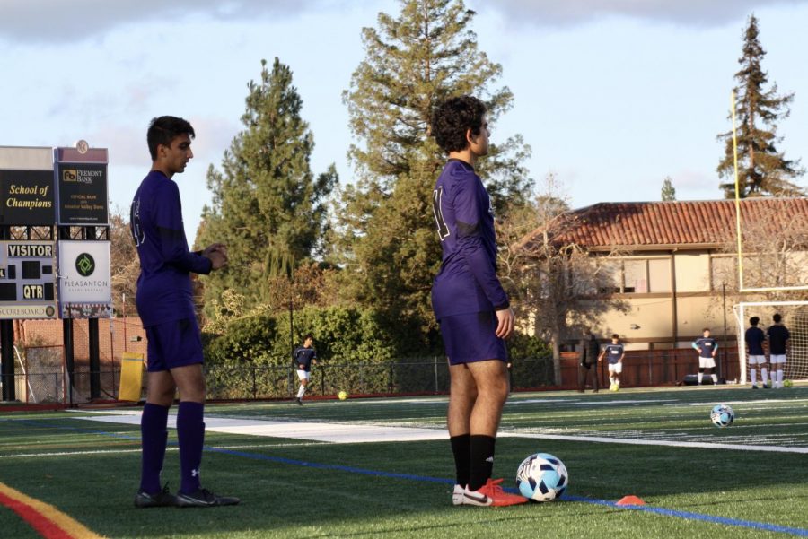 Ajay Reyes (24), and Saksham Nirvan (23) warm up before the game begins. 