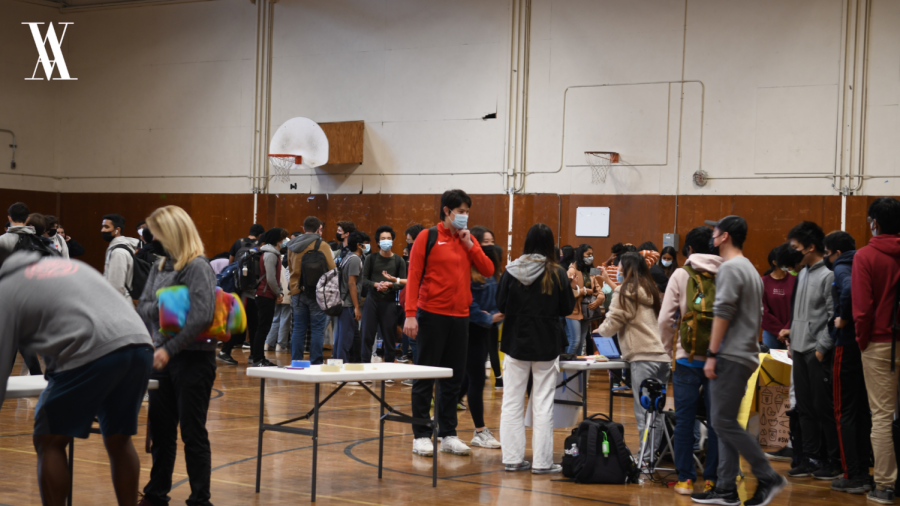 Students wandered around the small gym, as various clubs tried to attract more potential members.