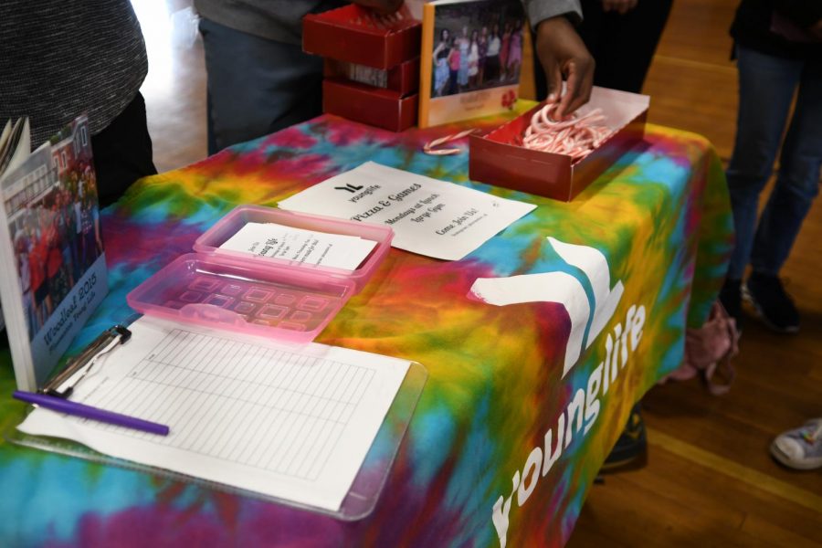 AVHS young life club shows students their photobooks and offers them candy canes.