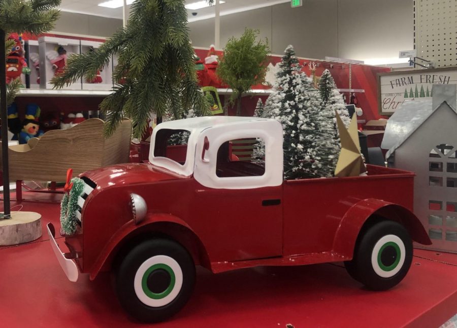 One decor idea from Target is a painted metal car carrying Christmas trees.