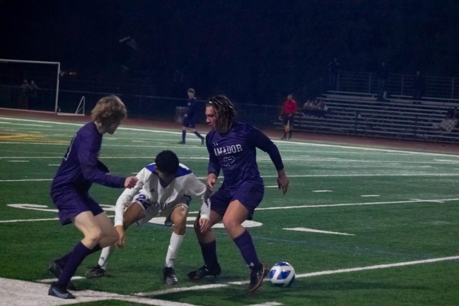 Andrew McMasters (22) and Fionn Conway (23) approach a Foothill player from both sides to steal the ball.