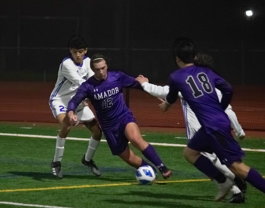 Andrew McMasters ('22) moves to kick the ball into Amador's possession.
