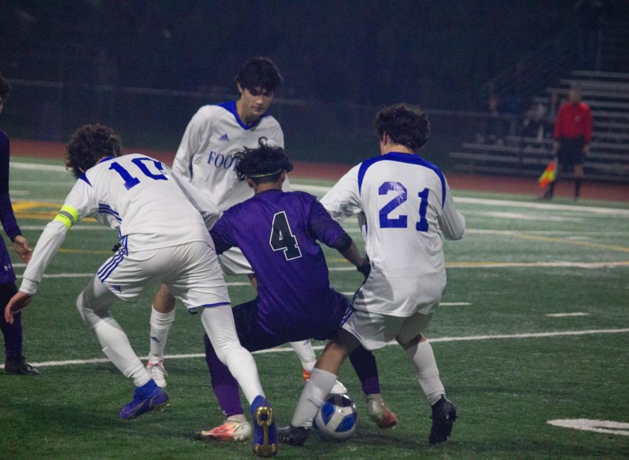 Razin Choudhury (23) takes control of the ball, surrounded by three Foothill players.