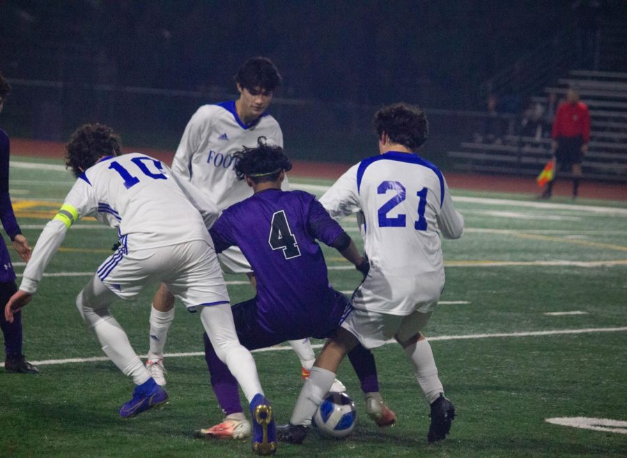 Razin Choudhury ('23) takes control of the ball, surrounded by three Foothill players.