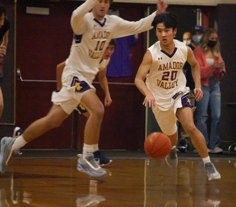 Bryce Osaki (22) moves down the court to take his shot.