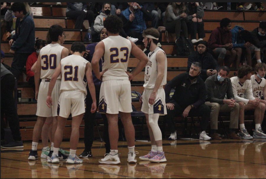 Abe Tabatabian (22), Tyler Cheng (22), Brady Nassar (22), and Foster Keast (22) planning their next move on the court.