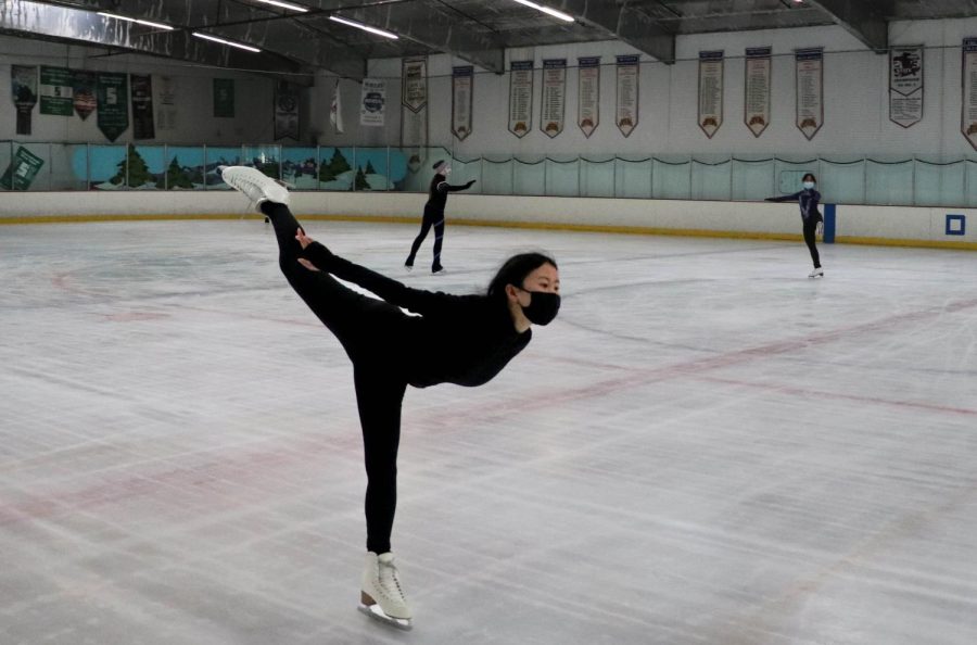 Sherry Long ('23) balances on one foot as she raises her leg high in the air.