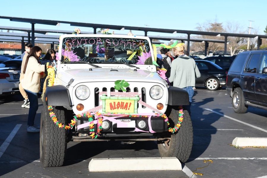 Four seniors decorate the Jeep with Hawaiian theme for the car show.