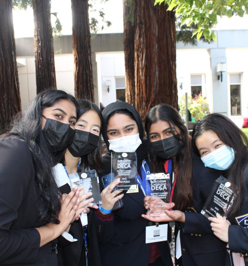 AVHS DECA officers and club members holds their glass plaque award together after the awards ceremony at the conference.