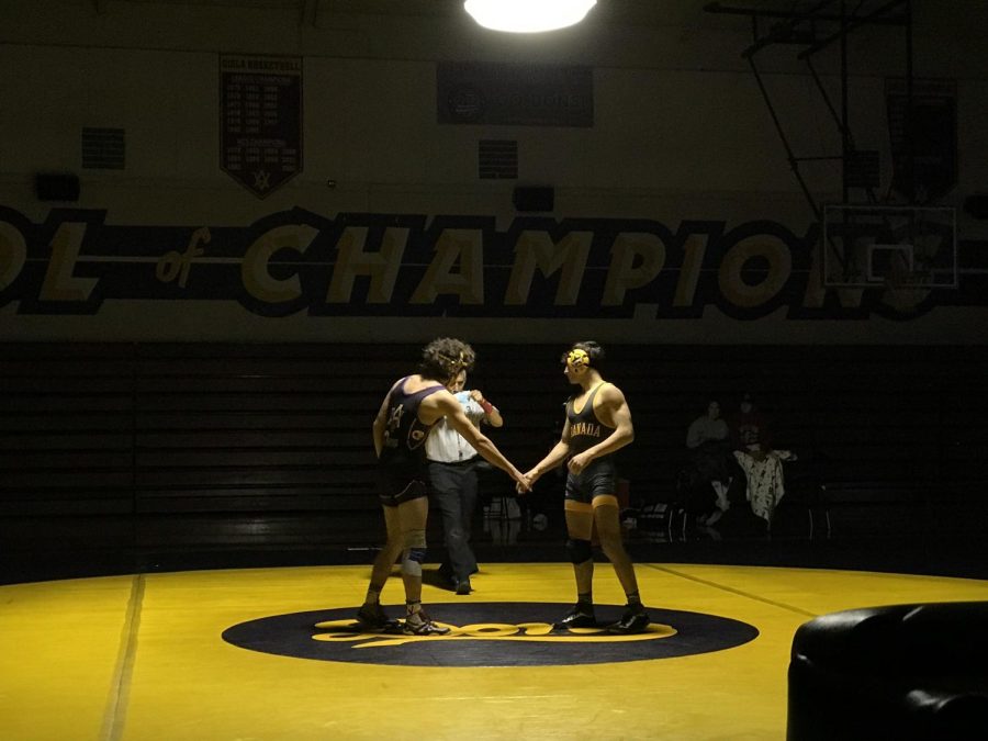 Amador wrestler Demetrio Lozrares (22) and Granada high school player shake hands before a game.