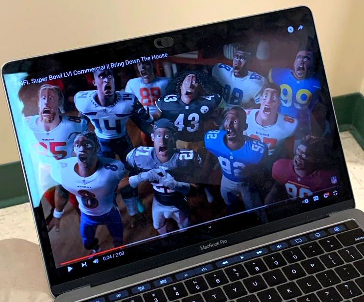 Jalen Alami (‘24) watches his favorite Super Bowl commercial entitled NFL: Bring Down the House," enjoying its creative humor.