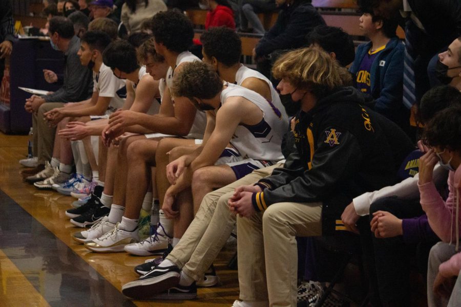 Amador players rest on the bench, ready to be subbed in at any point in the game.