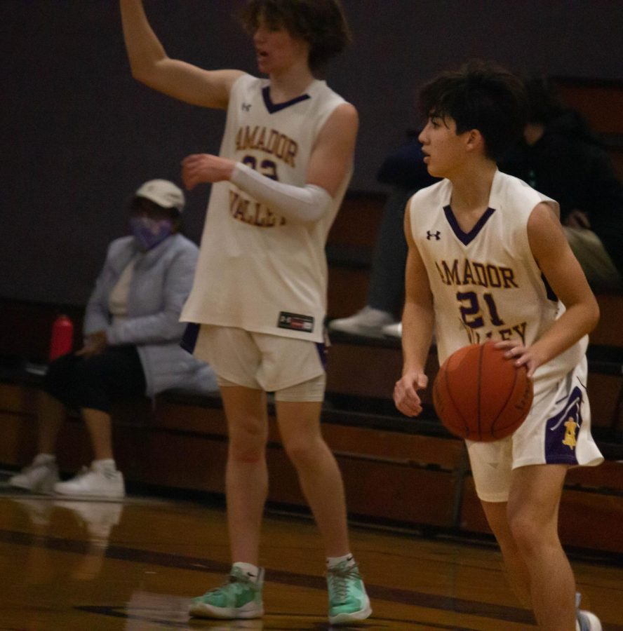 Tyler Cheng ('23) gets ready to move the ball as Colton Cash ('23) signals in the background.