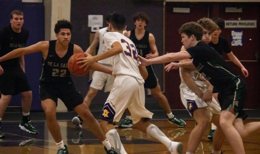 Ethan Daley ('22) gets ready to pass as De La Salle attempts to steal the ball.