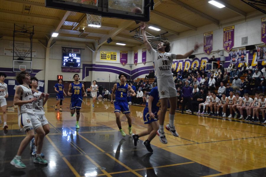 Colin Wallace ('23) leaps through the air attempting to score.