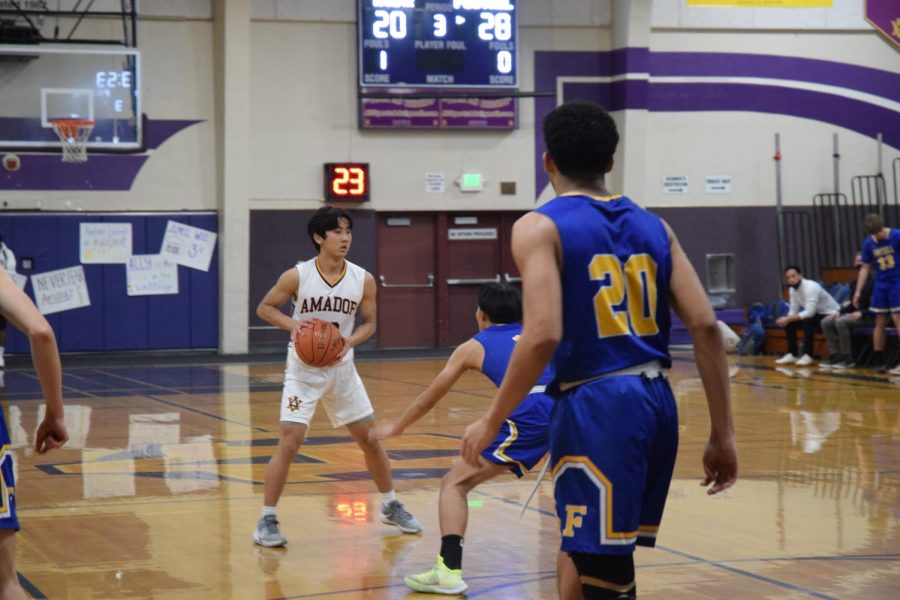Bryce Osaki ('22) attempting to move past Foothills' practiced defense.