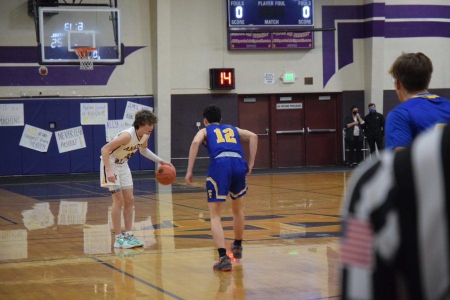 Colton Cash (23) eyes his peripheries, looking for a teammate to pass the ball to.