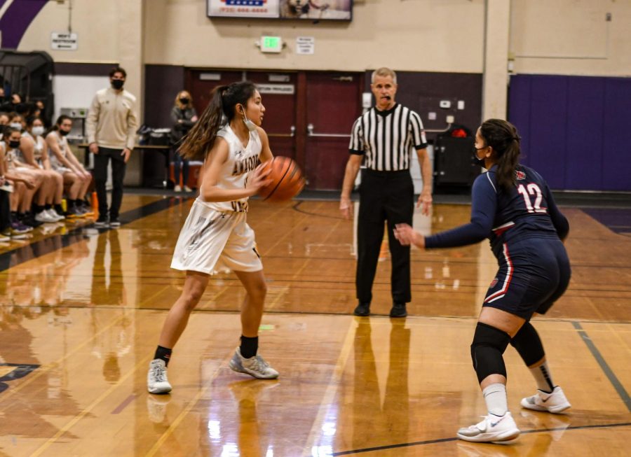 Riann Sarno (22) looks for a teammate to pass to.