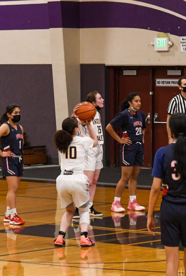 Gianna Ghio holds the ball in a professional gesture as she takes her free throw.