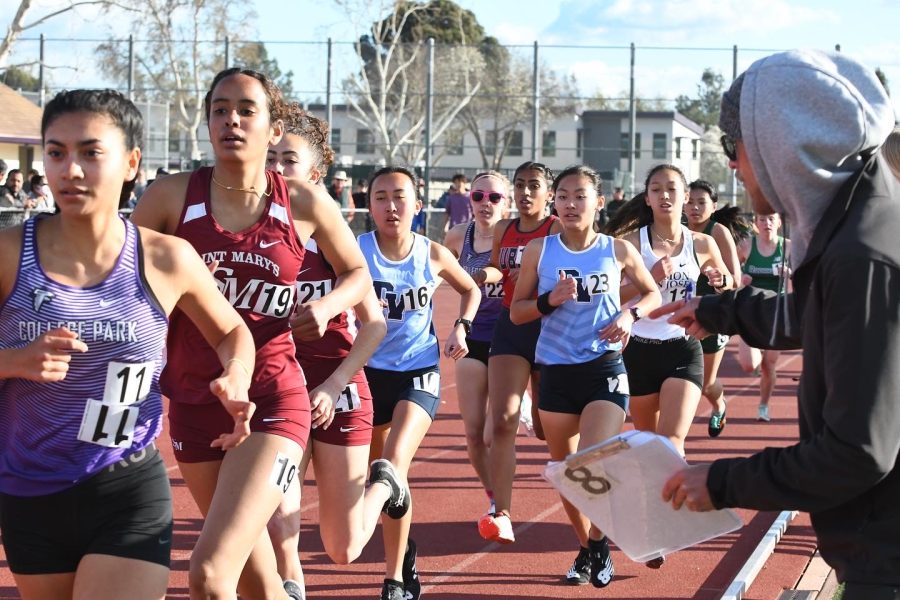 Coaches+run+on+the+sides+of+the+field+to+cheer+for+athletes.