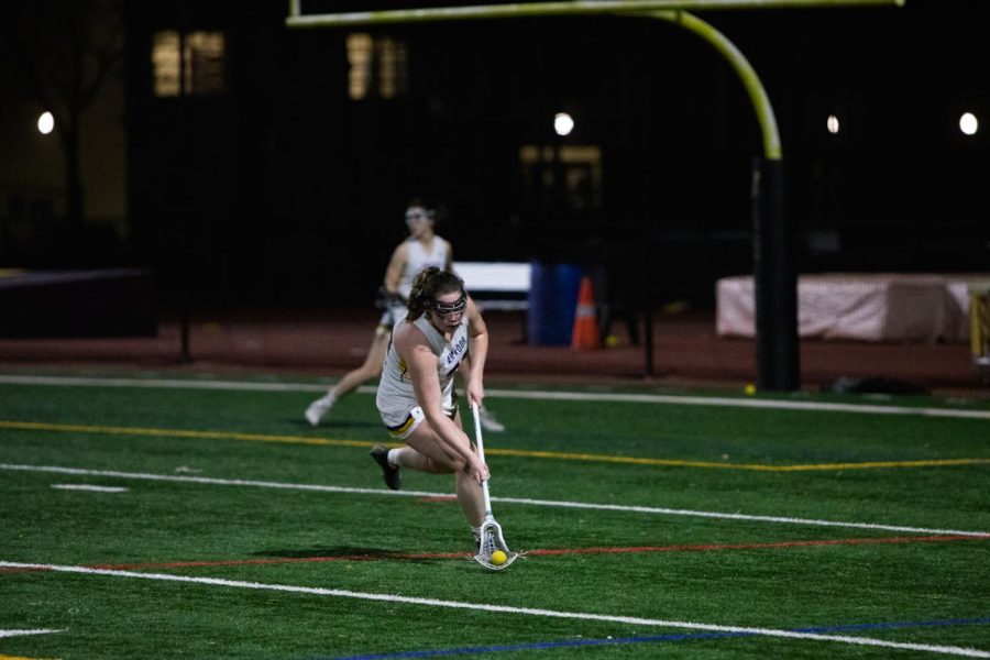 Lily Keegan ‘23 scoops up a loose ball.