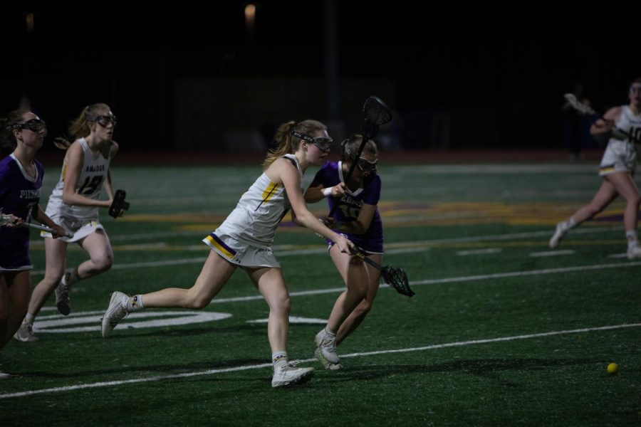 Ashley Heck ‘22 fights Piedmont defenders for posession.