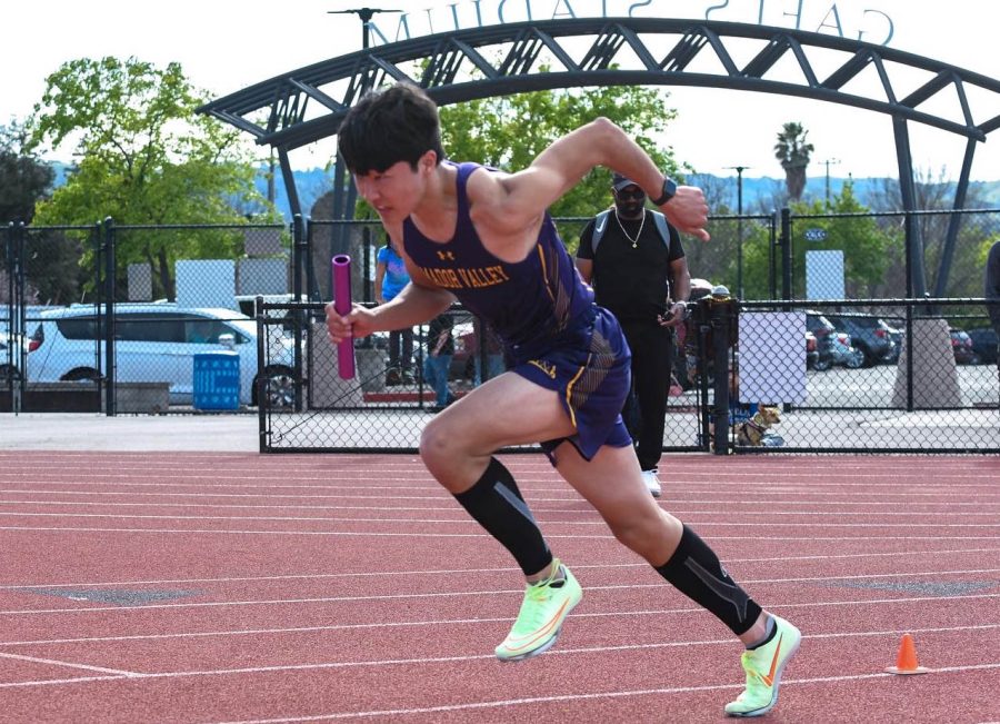 Declan Mcpherson (23) gets off to a fast start in the 4x400m relay race.