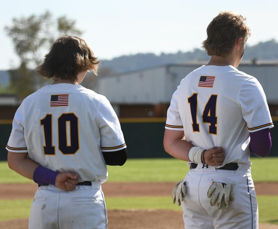 Blake Bouchard ('22) and Ethan Jackson ('23) pledge to the flag before the game starts.