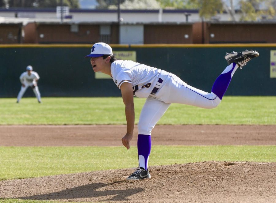 Tyler Kubo (23) pitches the ball with a fast speed.