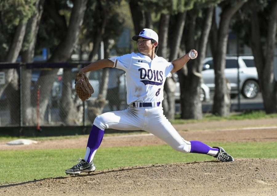 Tyler Kubo ('23) takes a deep lounge to pitch the ball.