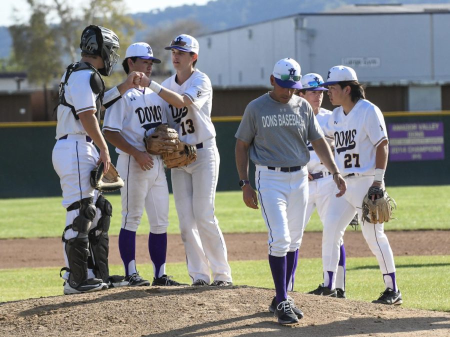 The team fist bumps each other after the coach brings them together for a talk.