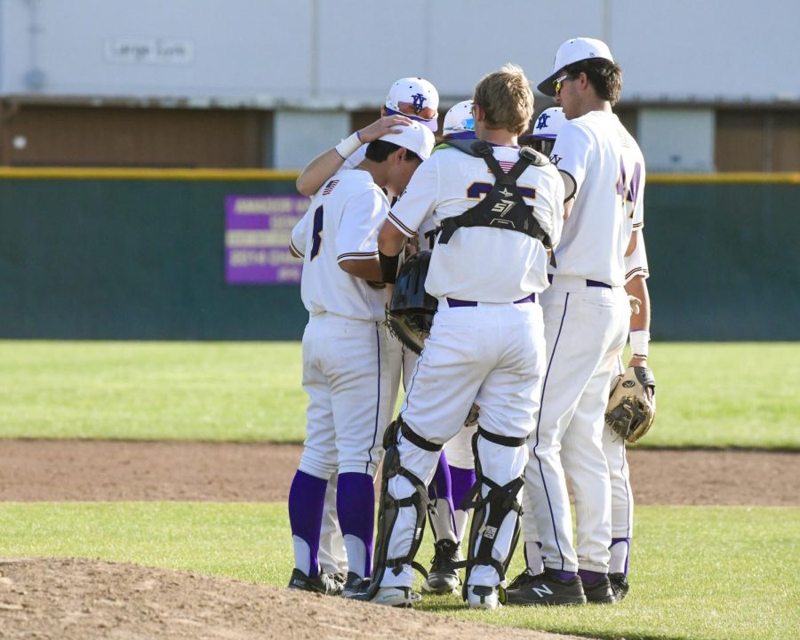 The team huddles after a play.