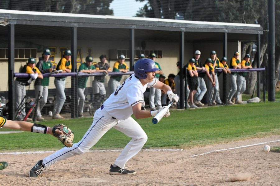 Ryan Lau ('22) knocks the ball lightly instead of taking a full swing.