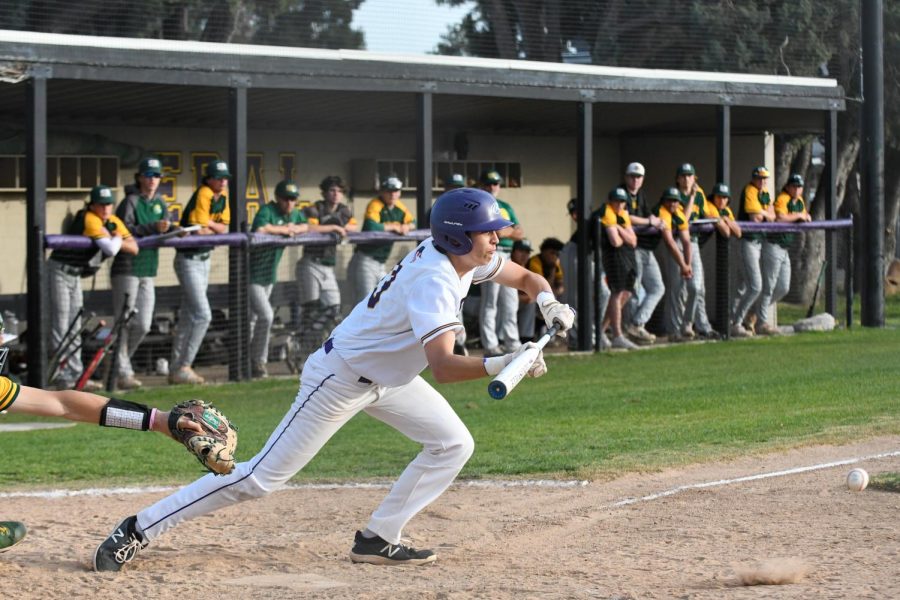 Ryan Lau (22) knocks the ball lightly instead of taking a full swing.