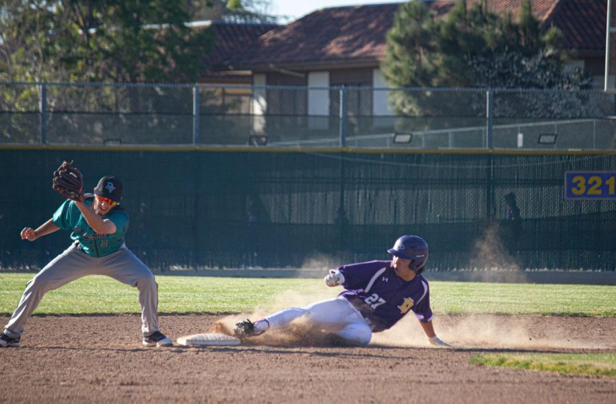 Ross Kobayashi (23) slides in at second base.