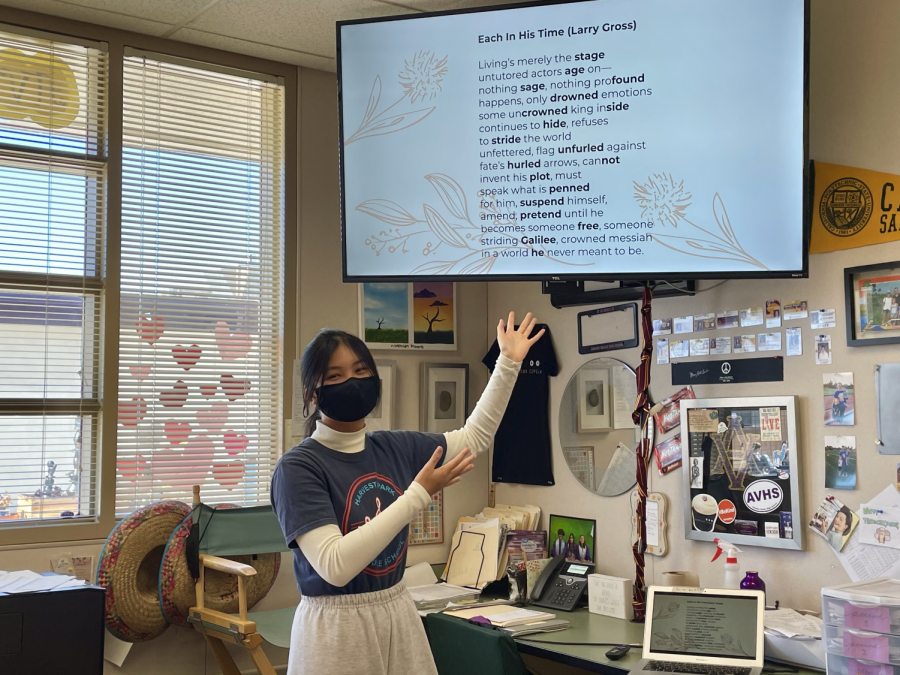 Tho Nguyen (23'), AWE co-president, reviews sample poems to club members at one of their weekly Tuesday meetings.
