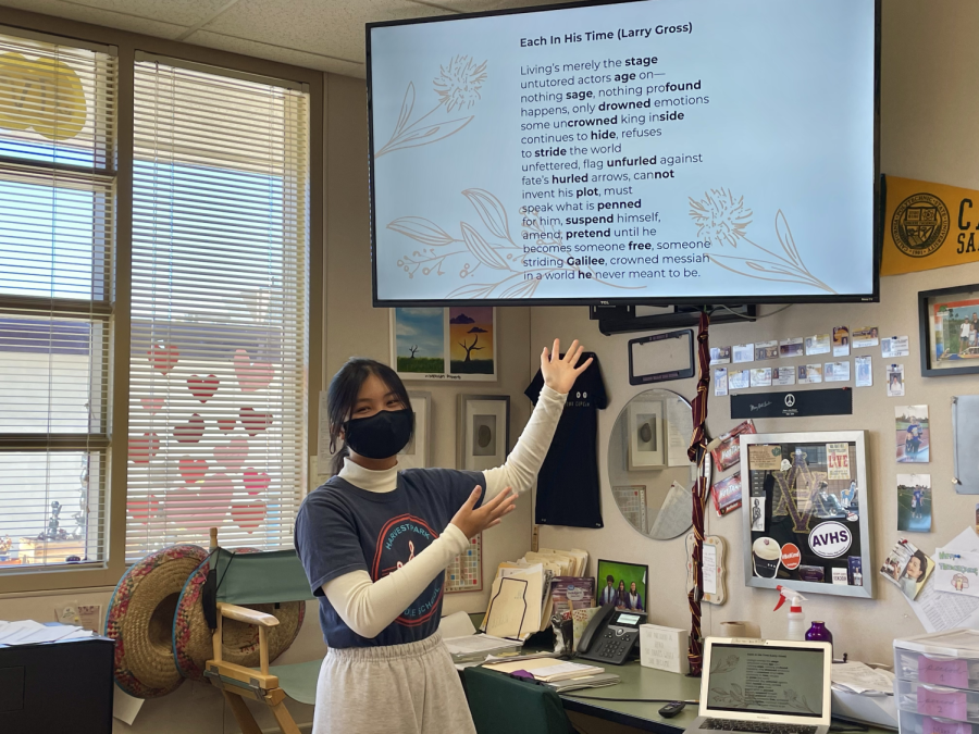 Tho Nguyen (23), AWE co-president, reviews sample poems to club members at one of their weekly Tuesday meetings.