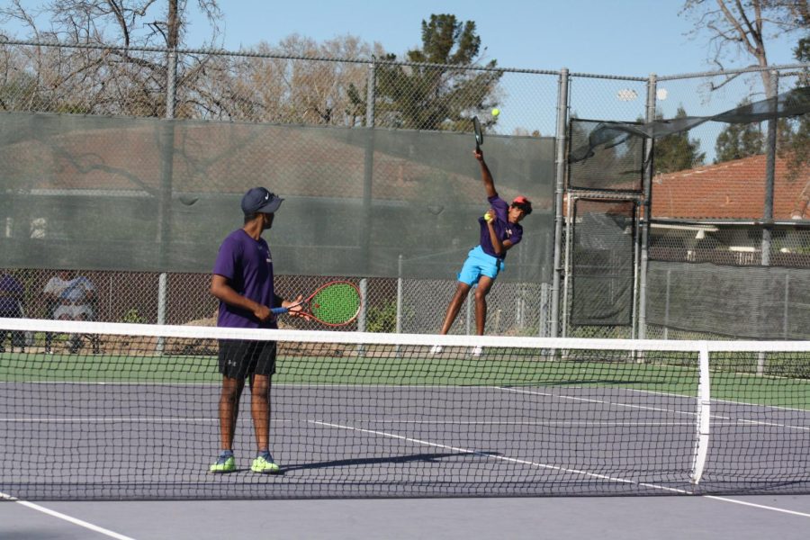 Anuraag Aravindan(23) puts a great amount of effort, jumping high in the air, to reach the ball while working with his partner Vikram Murali (23).