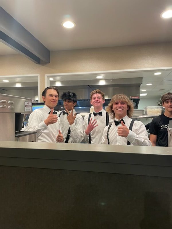 Ryan Lau, Aadit Policepatil, Matt Carter, and Blake Bouchard working in the Sidetrack kitchen. 
