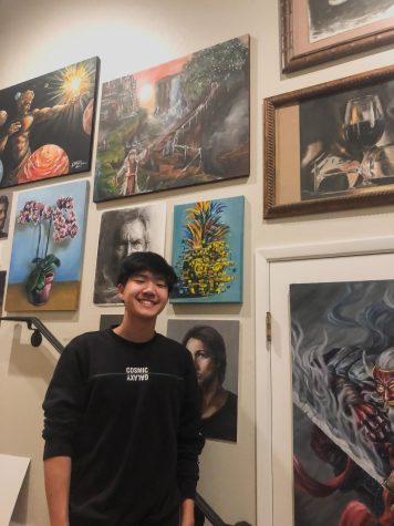Steven Liu (22) stands at home surrounded by art. 