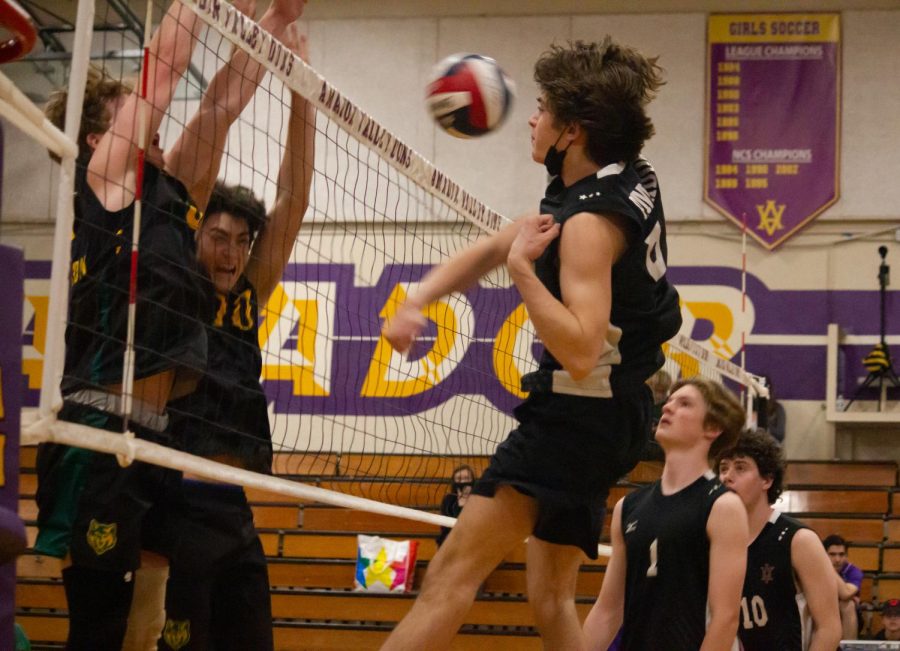 Luke Melvin ('23) attacks against two blocking SRV players.