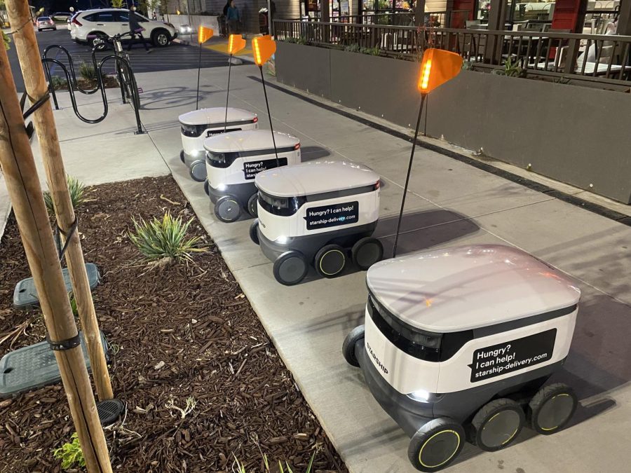 4 of Luckys robots stationed outside the store waiting to deliver food.
