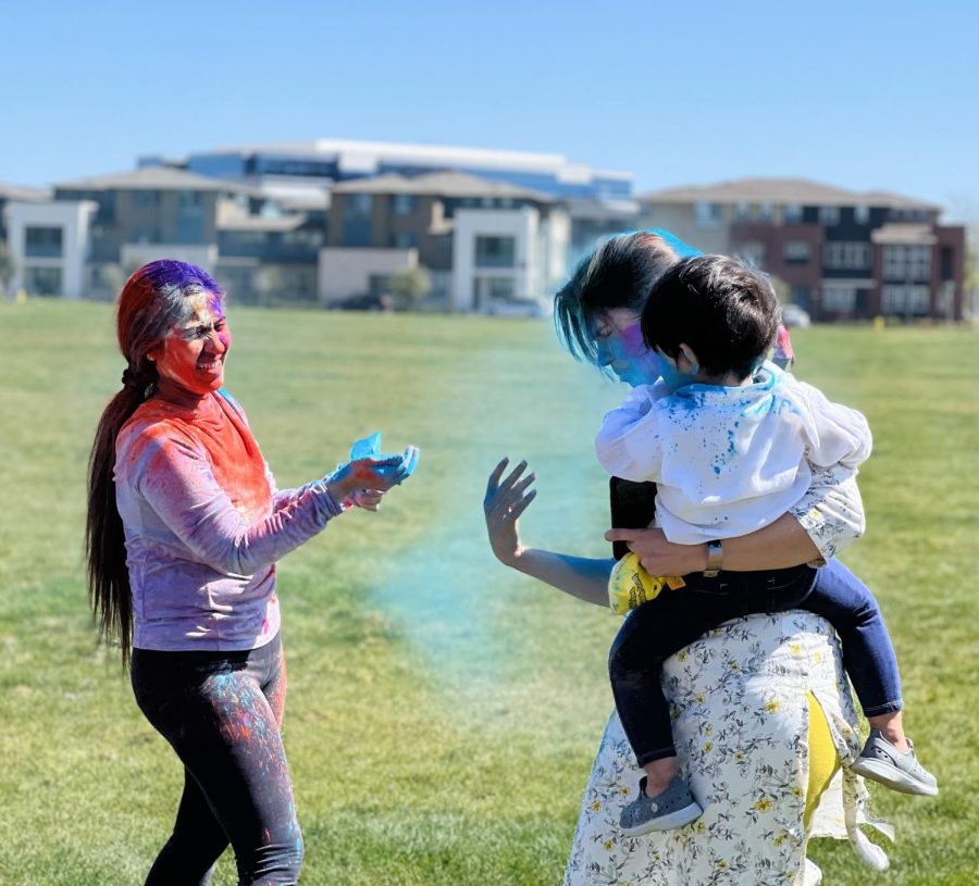 Holi powders color the ground and fill the air as attendees are bombarded with colors from all directions in the spirit of celebration.