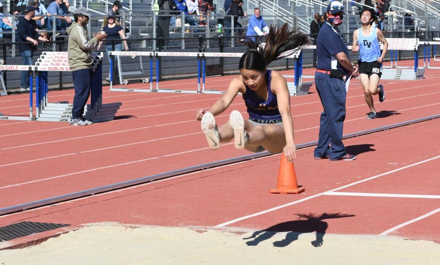 Kiana Lum ('22) takes a huge jump in the long jump.