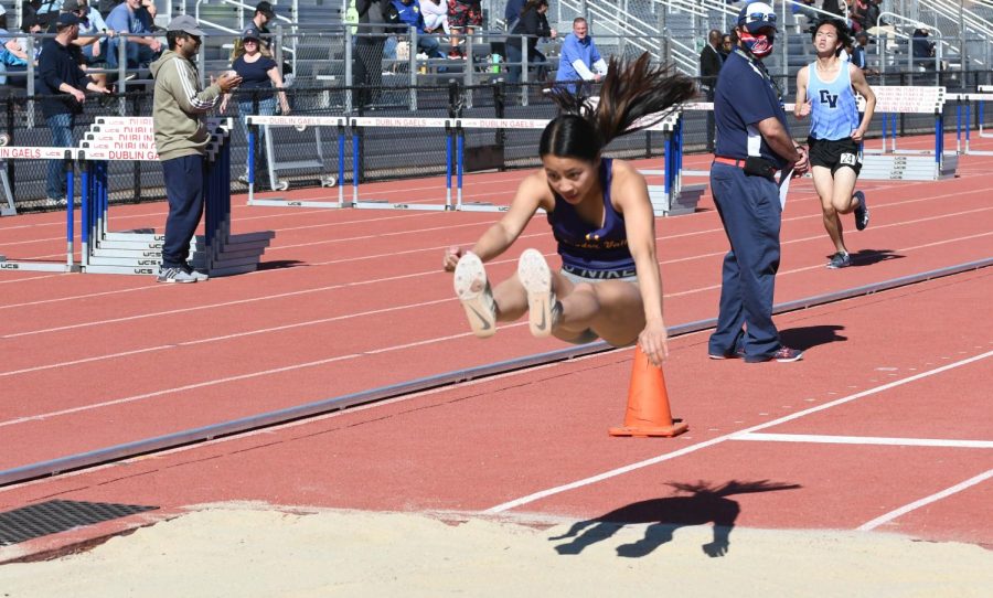 Kiana Lum (22) takes a huge jump in the long jump.