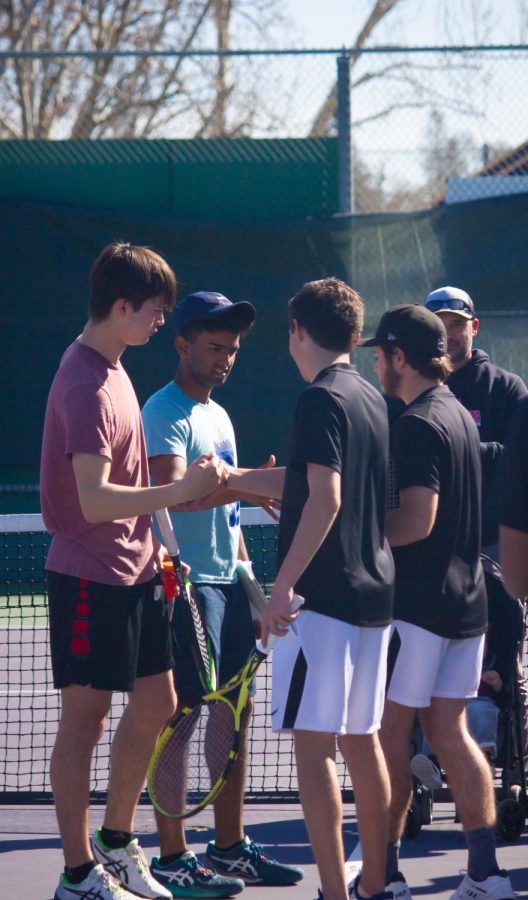 Doubles partners Nolan Smith (23) and Vikram Murali (23) shake hands with their Monte Vista opponents.