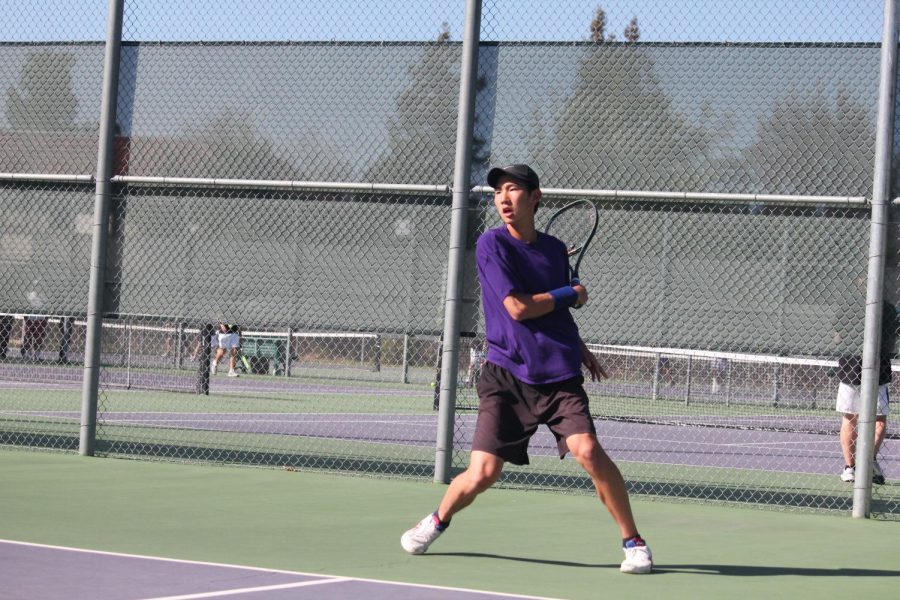 Minsung Kim (25) scores a point in his singles match.