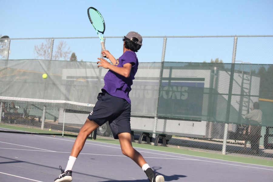 Rohan Patil (25) prepares to send the ball over the net.